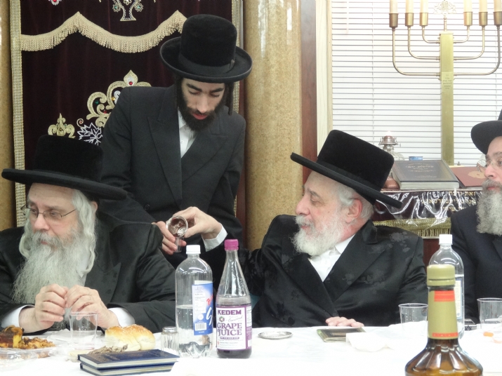 Liska Rebbe giving Kos shel brocha to his grandson Rav Alexander Sender Friedlander, , , ezra friedlander