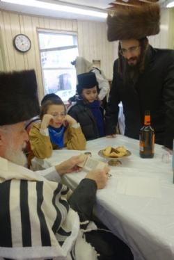 Liska Rebbe admiringly examines miniature Megilla written by Harav Meir Paneth, Meir Paneth