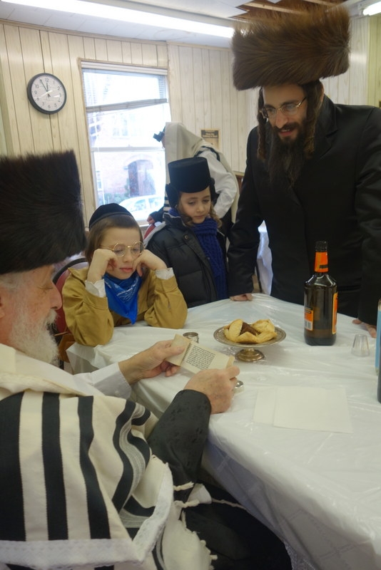 Liska Rebbe admiringly examines miniature Megilla written by Harav Meir Paneth, Meir Paneth, , ezra friedlander